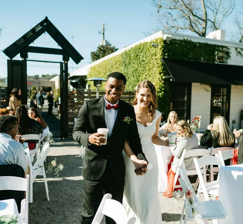 Bride and groom with coffee from the Cala Coffee cart at an outdoor wedding