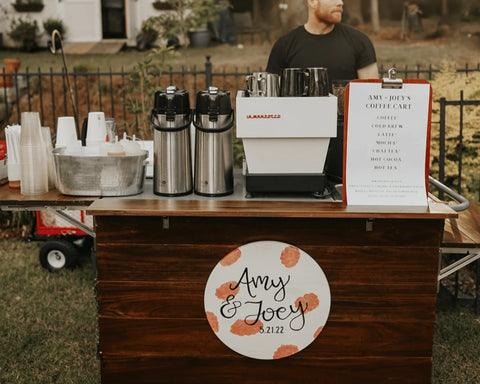 Cala Coffee cart set up at a wedding with a custom welcome sign